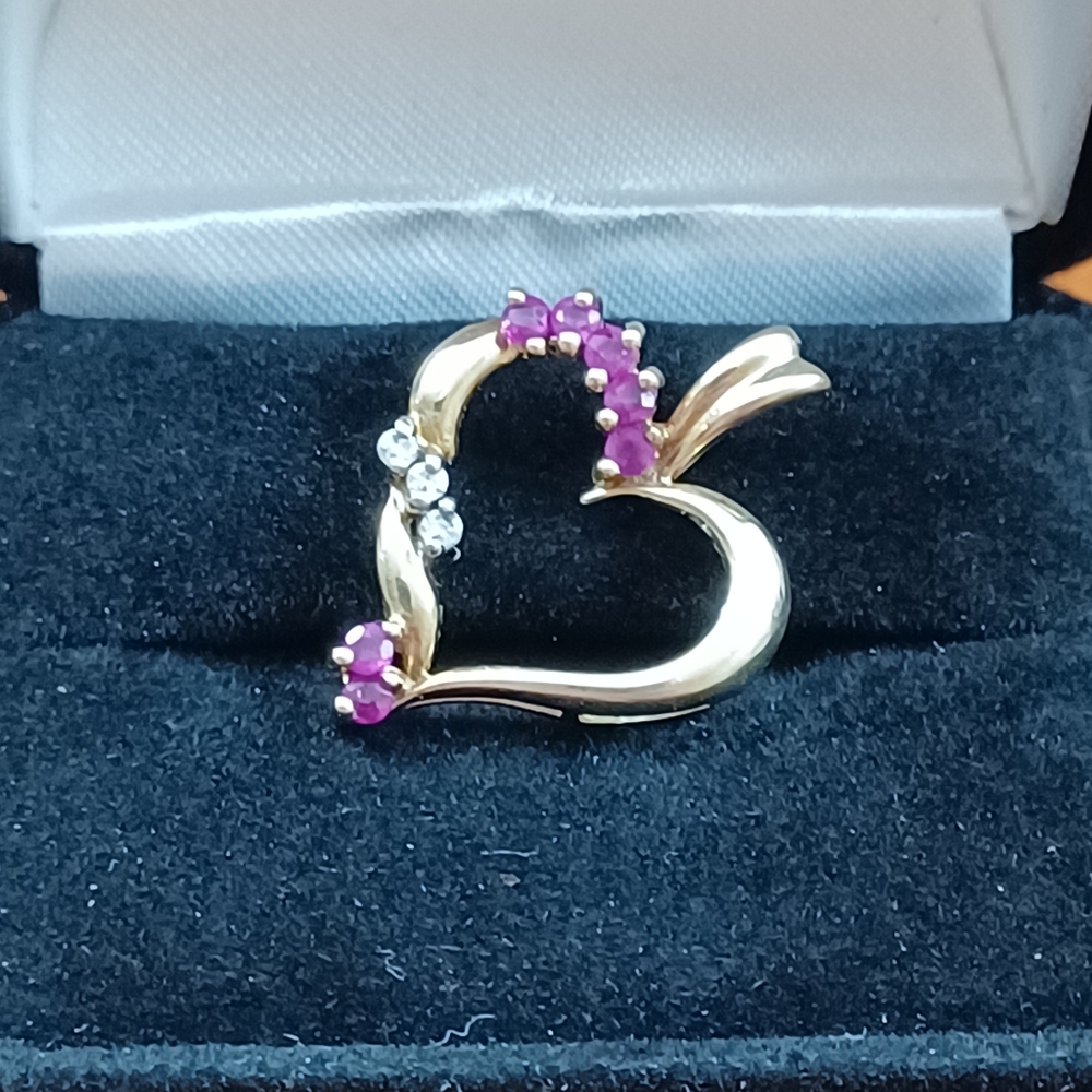 Genuine ruby and Dimond set in solid 14k yellow gold.